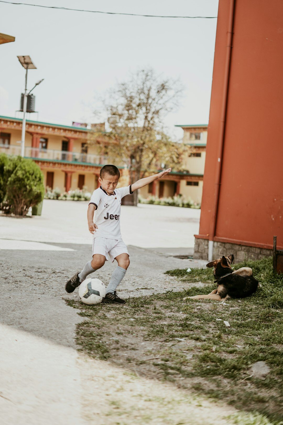 kids playing soccer in street
