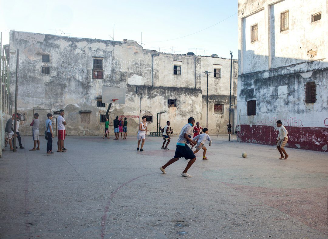 Children playing soccer on a dusty street in a Chilean neighborhood